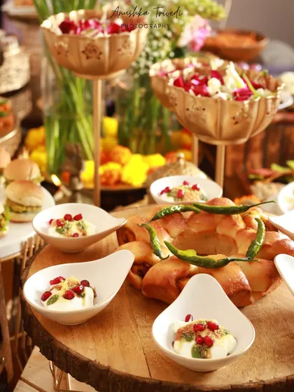 A vibrant and abundant food spread at a Diwali party. This shot captures the energy and variety of a festive buffet, from dahi vada to mini burgers.