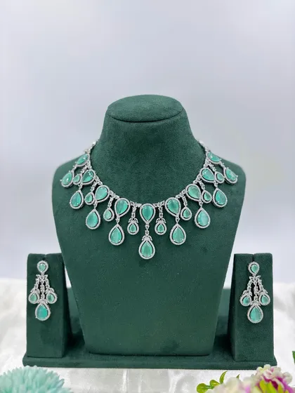The same teardrop AD necklace design with a lighter, sea-green stone.