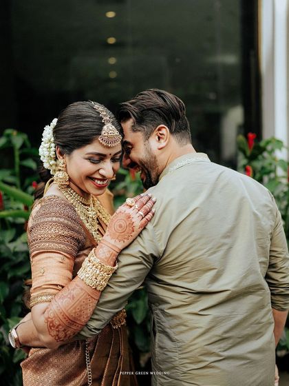 A candid moment of shared laughter, capturing the genuine joy and comfort between the couple.