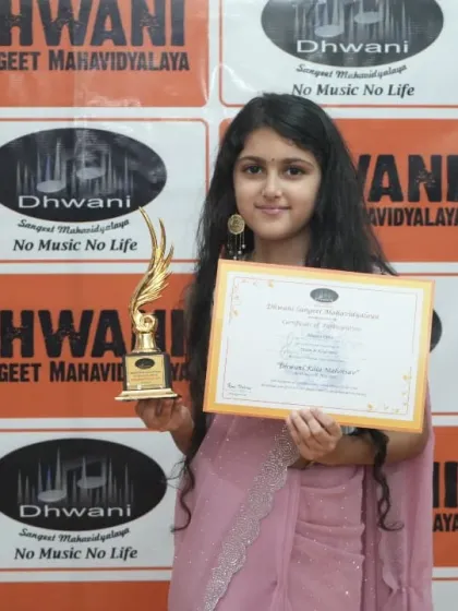 A graceful student poses with her award, reflecting the poise and creativity we nurture.