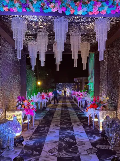 A closer look at the glamorous Sangeet entrance, with its sparkling walls, crystal chandeliers, and decorative mirror-finish elephants.