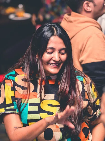 A smiling face in the crowd, enjoying the music.