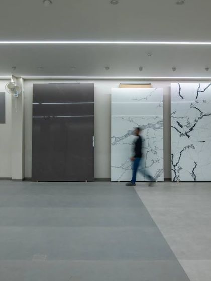 More images from the Krsimar marble showroom, detailing the sliding panel display system and the clean, spacious layout designed for an optimal client experience.