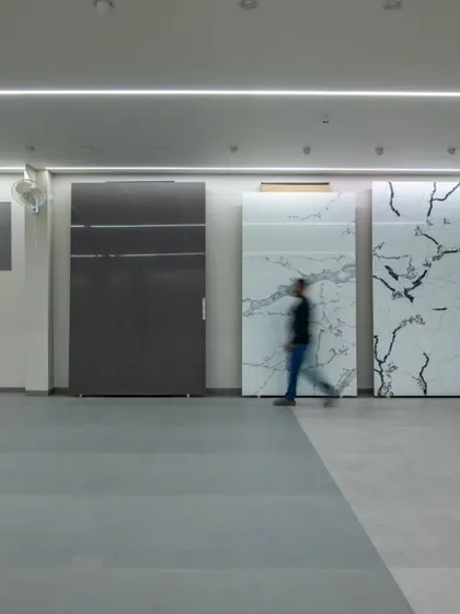 More images from the Krsimar marble showroom, detailing the sliding panel display system and the clean, spacious layout designed for an optimal client experience.