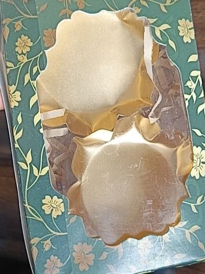 A decorative green floral box, shown here with two golden lotus urlis inside. This demonstrates another creative way to use my gift boxes for packaging.