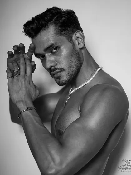 A striking black and white studio portrait for a fitness model. By stripping away color, we draw attention to the form, definition, and intense expression, creating a powerful and artistic image for a professional portfolio.