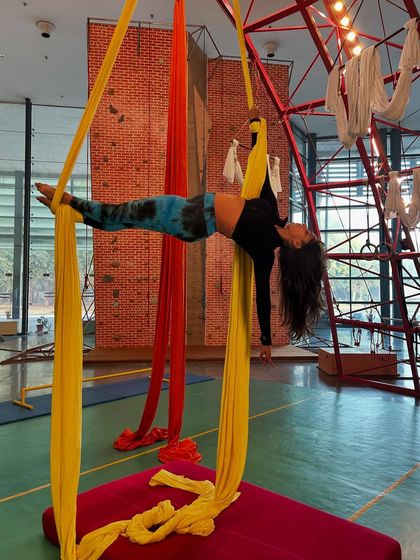 Holding a horizontal pose mid-air requires incredible full-body engagement. Our classes guide you through the progressions to achieve moves like this.