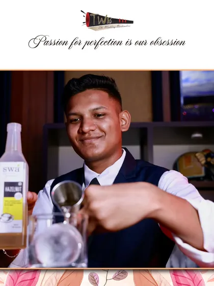 A bartender carefully measures hazelnut syrup, showcasing the precision required to create perfectly balanced signature drinks.