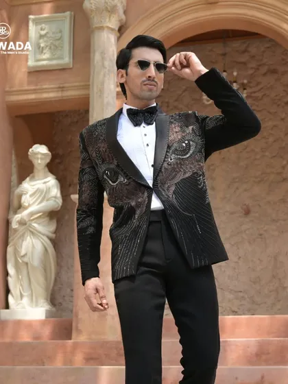 The eye-motif tuxedo in a full-length pose, showing how the design creates a powerful and modern aesthetic. Paired with sunglasses, it's the epitome of cool confidence.