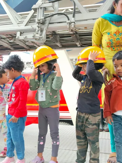 Field trips introduce children to community helpers. A visit to the local fire station was a huge thrill, where they got to learn about safety and even try on a real firefighter's helmet.