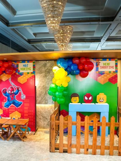 A wider view of the LEGO-themed game stalls, including "Nerf Shooting" and another activity station.