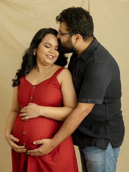 A simple and sweet couple's portrait. The red dress adds a pop of color, while the tender embrace captures the love and warmth between you.