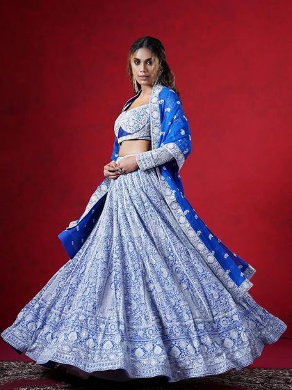 A stunning blue and white embroidered lehenga, perfect for making a bold statement. The intricate patterns give it a royal feel.