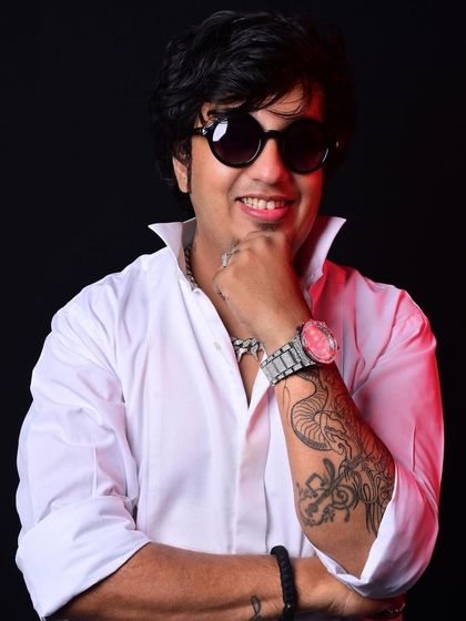 A close-up shot showing my tattoo and confident smile. This is the persona I bring to my DJ booth every night.