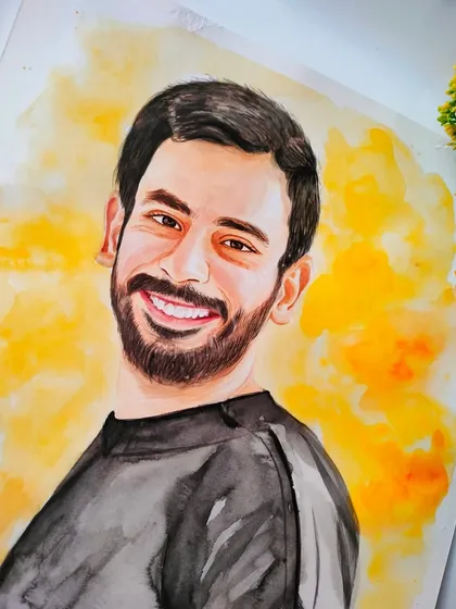A detailed shot of the man's face in the watercolor portrait, highlighting the careful blending of skin tones and the light in his eyes.