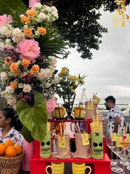 A beautiful display of fresh flowers and fun glassware at our pool party bar. We believe the bar should be as beautiful as the rest of your event decor.