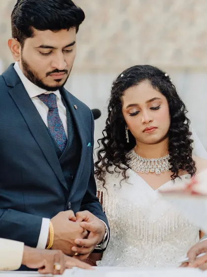 Signing the register, a pivotal moment. Her makeup is subtle and elegant, perfect for these close-up, emotional shots.