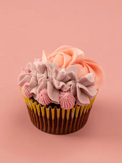 A stunning two-toned buttercream swirl on my signature Belgian chocolate cupcake. The combination of colors and piping techniques makes this a true work of art.