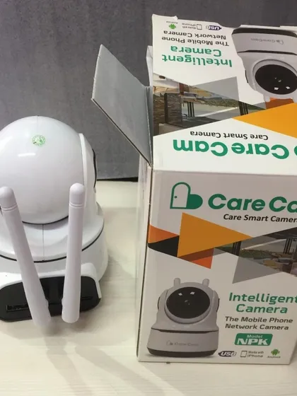 The Care Cam shown next to its packaging. This intelligent camera is a popular choice for families wanting to stay connected and ensure their home is protected 24/7.