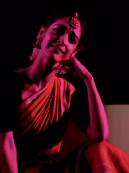 Capturing a moment of deep emotion, or 'abhinaya', during a Bharatanatyam piece. The subtle expression and posture convey the story of a nayika, a heroine lost in thought and longing.