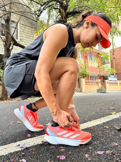 Lacing up my Adizero SLs before a run. The ritual of getting my gear ready helps me get into the right mindset for the training session ahead.