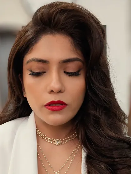 Another view of the classic red lip and winged liner combination. This look is all about precision and balance, creating a powerful yet elegant statement.
