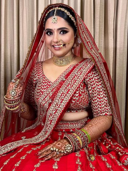 A happy bride is the prettiest bride. This look in a classic red lehenga is all about radiance and joy, with makeup that enhances her natural beauty.