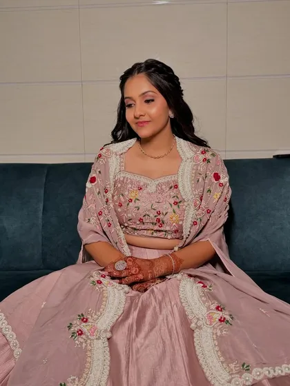 A soft and pretty Roka look. The floral-embroidered outfit is paired with a simple braided hairstyle and natural, dewy makeup.
