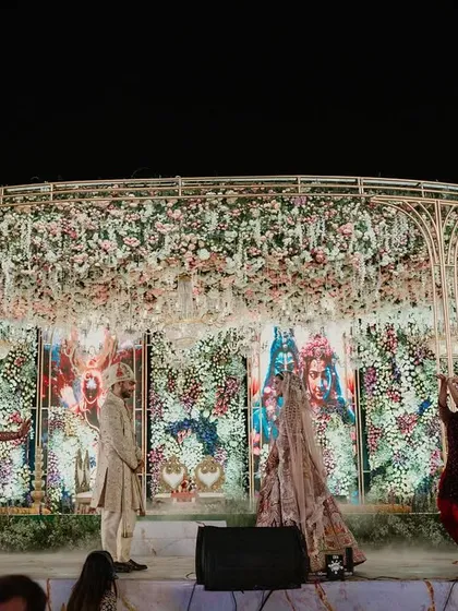The Varmala ceremony is the heart of the wedding. I designed this stage with a massive floral chandelier and a divine backdrop, with dancers adding to the grandeur as the couple prepared for their union.