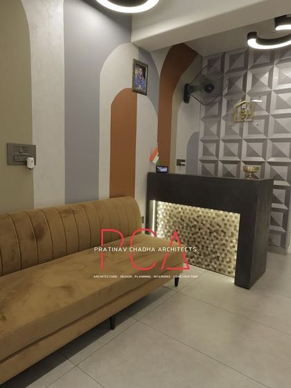 The reception and waiting area, showing the combination of the patterned wall, textured desk, and comfortable seating.