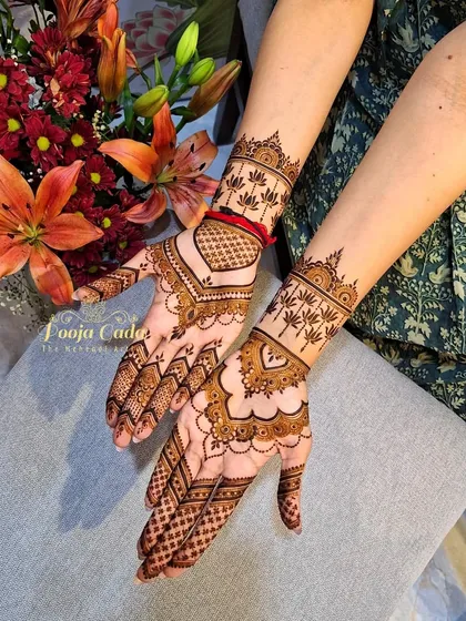 Minimalist henna can still make a beautiful statement. This delicate design is perfect for an engagement party or for a guest who loves an elegant, understated look, featuring fine lines, heart motifs, and lotus patterns on the wrist.