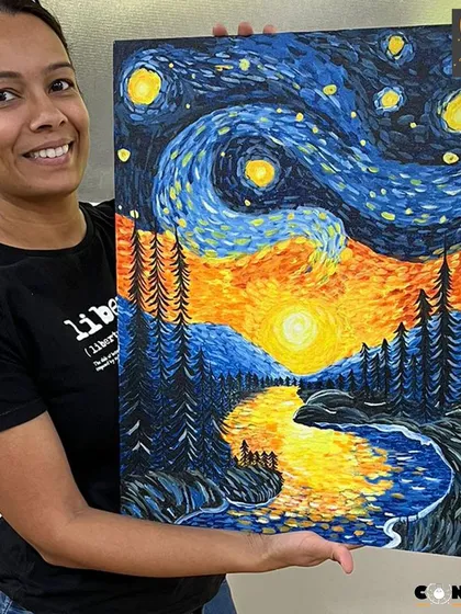 A student proudly displays her vibrant recreation of Van Gogh's 'Starry Night'. Our acrylic painting classes help you explore famous art movements and develop your own style, turning a blank canvas into a personal masterpiece.