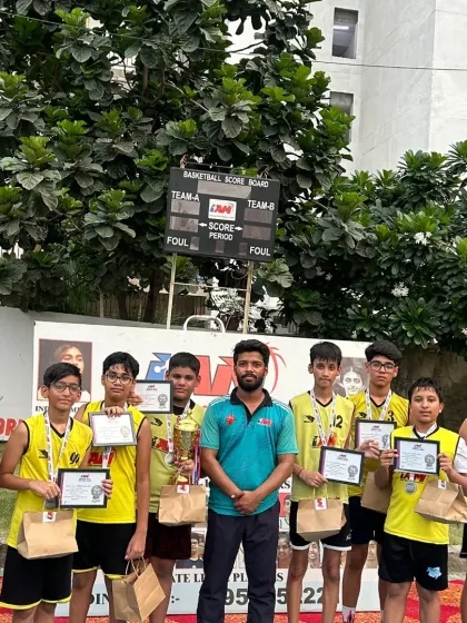 The winning boys' team and their coach with their trophy and certificates from the U-14 league.