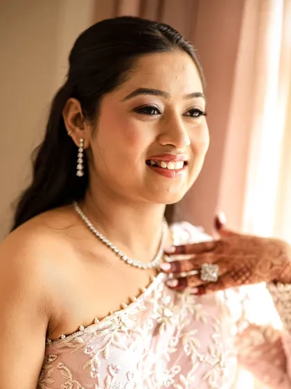 A beautiful, sun-kissed portrait of the bride, her face lit up with a happy smile.