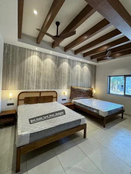 A hotel room I furnished, featuring two different bed designs. One is a mid-century style with a cane headboard, and the other has a rustic live-edge wood slab headboard.