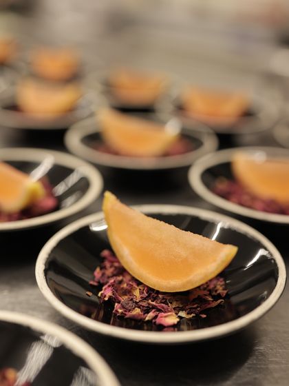 A delicate palate cleanser of citrus sorbet on a bed of rose petals, a thoughtful detail in our multi-course meals.