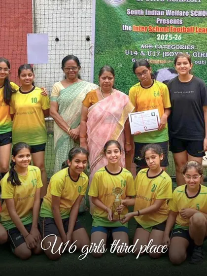 The Shishuvan U16 girls' team proudly accepts their third-place trophy at the Inter-School Football League, a testament to their grit and our coaching.