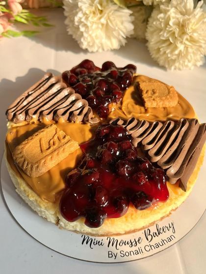 A top-down view of my assorted cheesecake, beautifully lit by the sun. This cake combines my most popular flavors: homemade blueberry, rich chocolate, and spiced Lotus Biscoff.