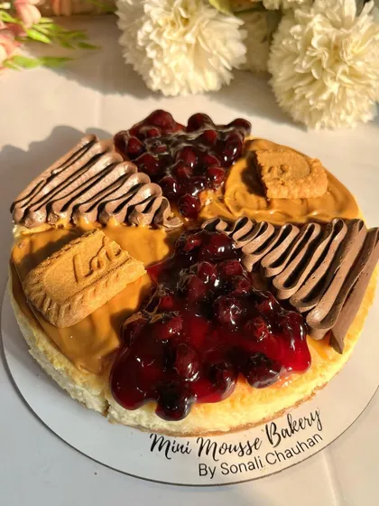 A top-down view of my assorted cheesecake, beautifully lit by the sun. This cake combines my most popular flavors: homemade blueberry, rich chocolate, and spiced Lotus Biscoff.
