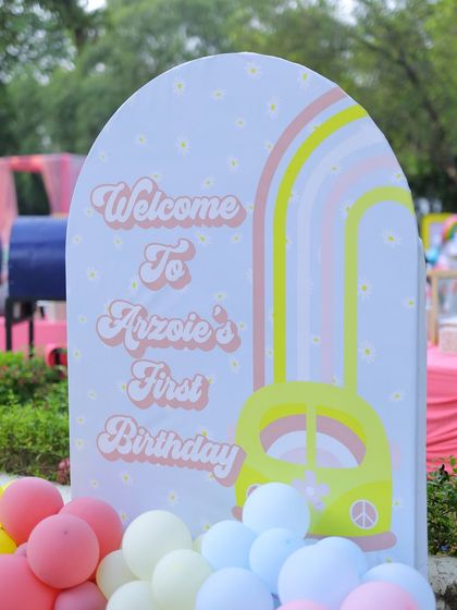 A closer shot of the arched welcome sign for the sunshine-themed party. The custom graphics and pastel colors create a warm and inviting entrance for guests.