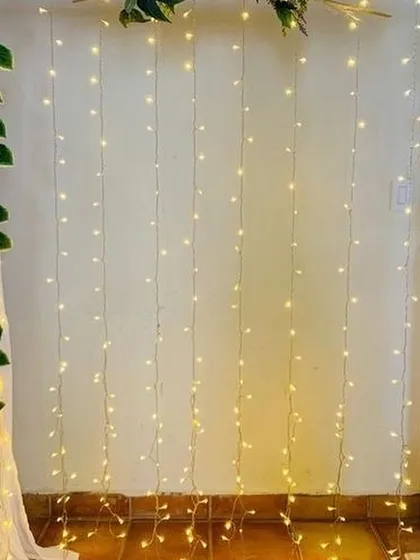 A simple yet beautiful Ganpati backdrop for an intimate home celebration. I use a curtain of warm fairy lights framed by fresh green vines to create a cozy and divine corner for your idol.