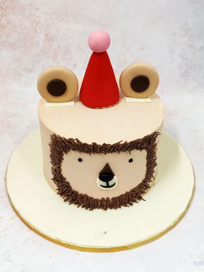 Our Simple Lion Cake offers a minimalist take on the theme, with a cute, stylized lion face and a little party hat.