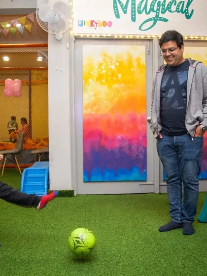 A father and son enjoying a game of soccer together. My space is designed for family fun.