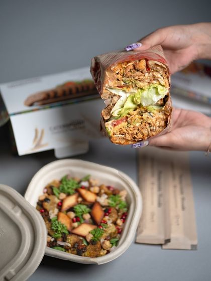 A warm, hearty, and wholesome meal ready to be enjoyed. This image shows our flavorful sandwich and nourishing rice bowl, packed and ready for delivery.