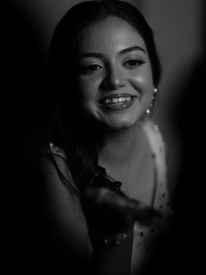 A candid black and white shot that captures a moment of pure joy. When the makeup slays and the love sparkles, you get moments like this.