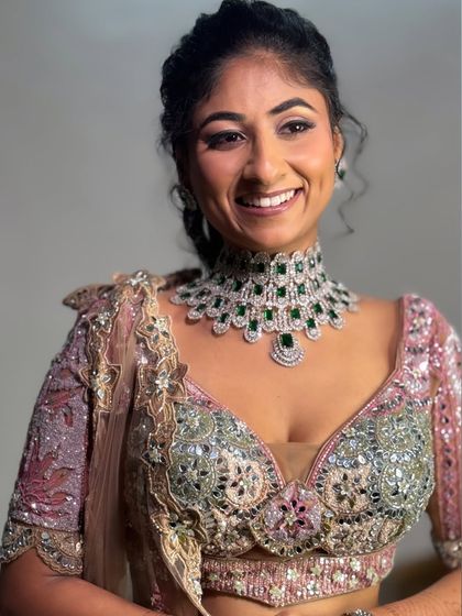 The final look. Her smile shows how happy and confident she feels, and that's always my goal. The diamond and emerald jewelry perfectly complements the colors in her outfit.