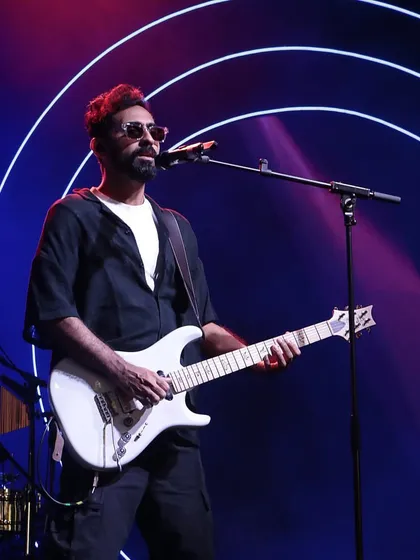 The guitarist from Sanam Band performing under the spotlight. We work with artists to create a dynamic and visually engaging show for your guests.