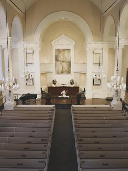 A wide shot of the empty church, with my sitar waiting on stage. There's a powerful stillness in these moments before the audience arrives and we fill the space with music and energy.