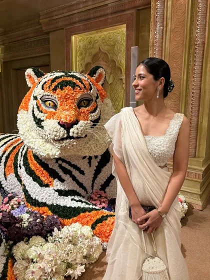 Posing with the incredible floral decor at the Ambani wedding. The grandeur of the event was the perfect backdrop for this classic and chic outfit.