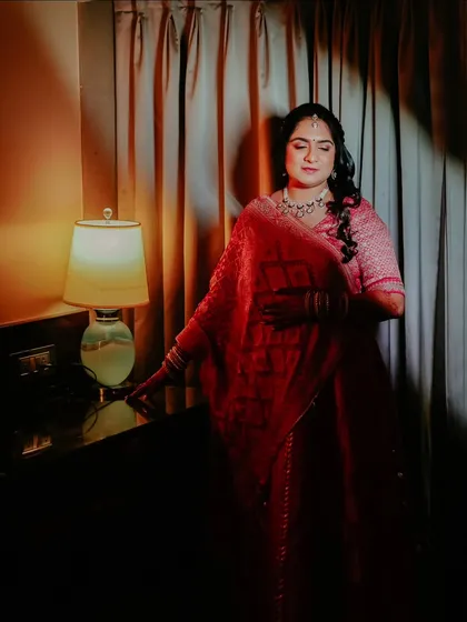 An elegant portrait of the bride-to-be, her features softly illuminated by a lamp, creating a warm and intimate mood.